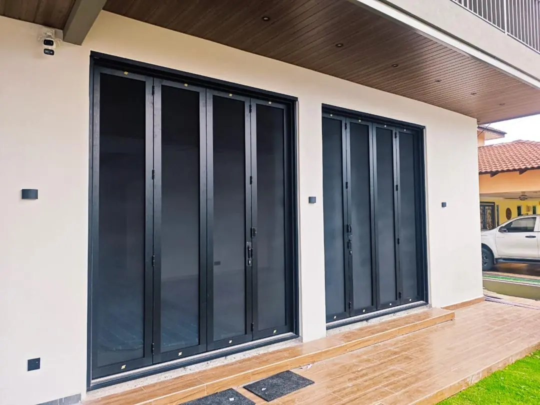 Windows & Doors 1 Black-framed aluminium sliding doors connecting a modern home interior to the outdoor area